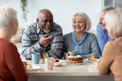 Group of older adults having brunch around a table.