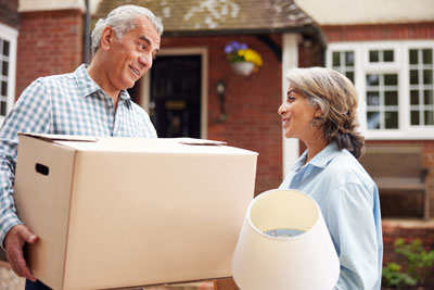 Older couple with boxes and a lamp downsizing.