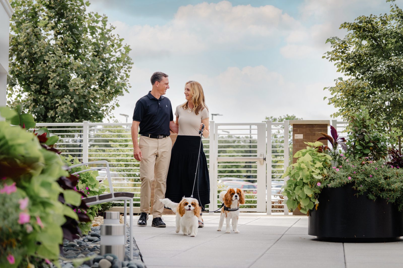 Couple walking dogs on Bailey Amenities Deck