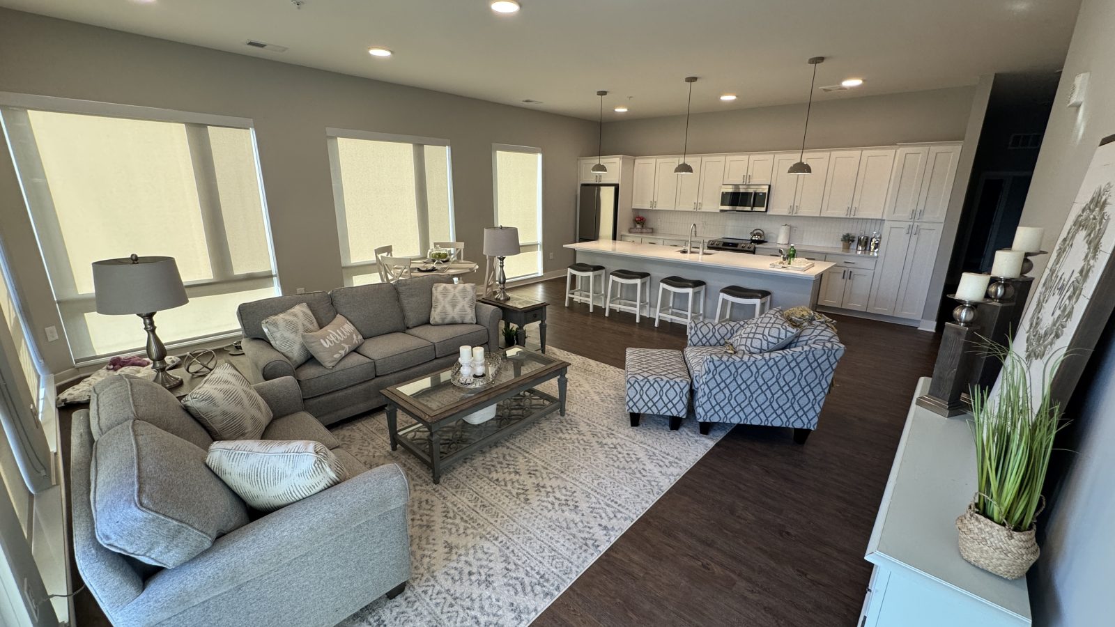 Open-concept living room and kitchen in The Starling, a modern 55+ apartment home at The Bailey at Bridge Park in Dublin, Ohio.